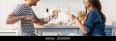 cropped view of happy couple holding glasses with wine, banner Stock Photo