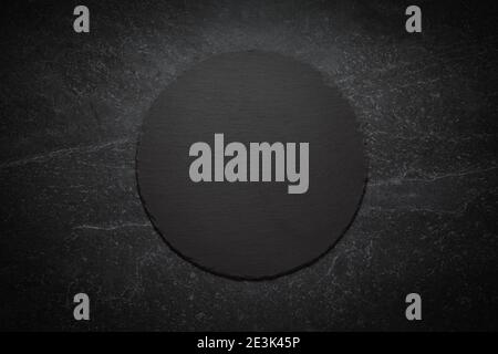round black slate board on marble background, image with space for text Stock Photo