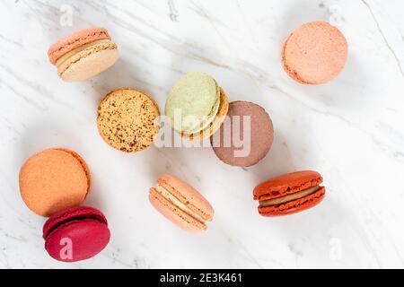 Colorful Fruity Macarons Flat Lay and Top View on White Marble Table Stock Photo
