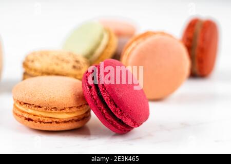 Colorful Fruity Macarons Flat Lay and Top View on White Marble Table Stock Photo