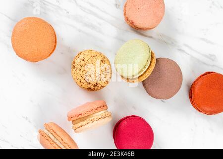 Colorful Fruity Macarons Flat Lay and Top View on White Marble Table Stock Photo