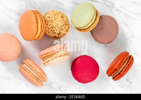 Colorful Fruity Macarons Flat Lay and Top View on White Marble Table Stock Photo