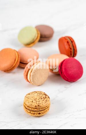 Colorful Fruity Macarons Flat Lay and Top View on White Marble Table Stock Photo