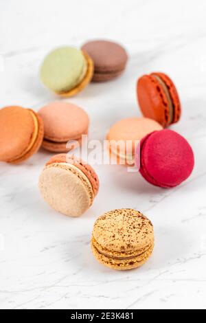 Colorful Fruity Macarons Flat Lay and Top View on White Marble Table Stock Photo