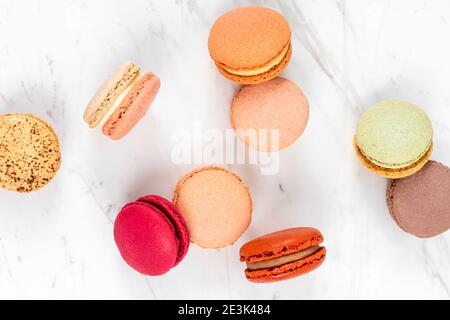 Colorful Fruity Macarons Flat Lay and Top View on White Marble Table Stock Photo