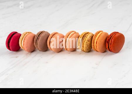 Colorful Fruity Macarons Flat Lay and Top View on White Marble Table Stock Photo