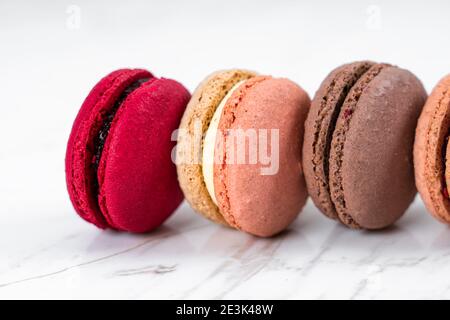 Colorful Fruity Macarons Flat Lay and Top View on White Marble Table Stock Photo