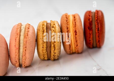 Colorful Fruity Macarons Flat Lay and Top View on White Marble Table Stock Photo