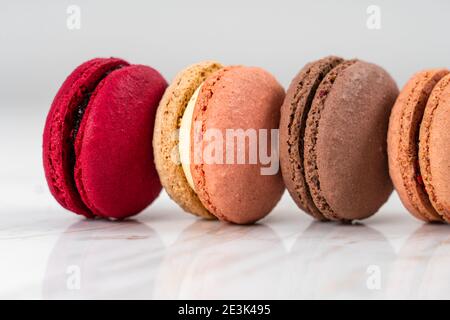 Colorful Fruity Macarons Flat Lay and Top View on White Marble Table Stock Photo