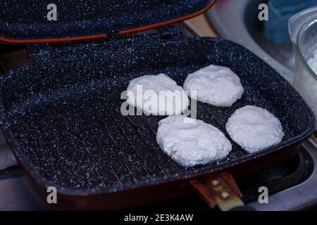 Fry cheese cakes at home in a pan Stock Photo