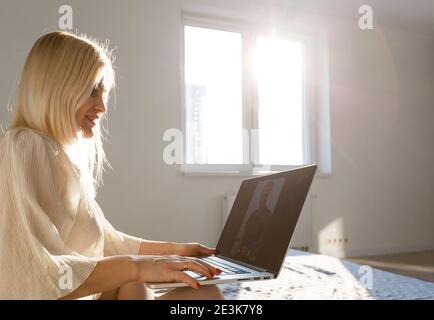 Middle-aged woman working from home on laptop Stock Photo