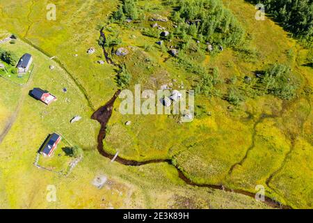 Aerial view of holiday cottages at a stream, valley near Tungestolen south of glacier Jostedalsbre, Sognefjord region, Norway. Stock Photo