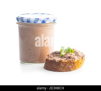 Liver pate on sliced baguette isolated on white background. Stock Photo