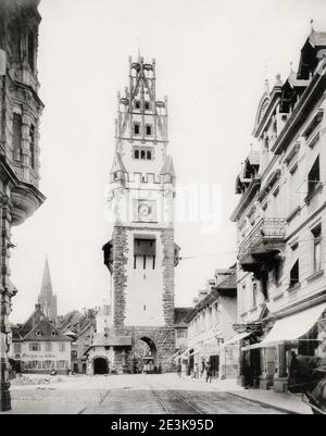 19th century vintage photograph: The Schwabentor (English Swabian Gate), also called Obertor in the Middle Ages, is the more recent of the two remaining city gates of the medieval defensive wall of Freiburg im Breisgau in Baden-Württemberg, Germany. Stock Photo