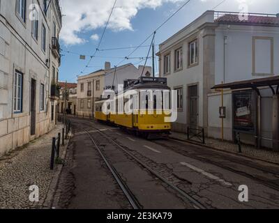 Classic Yellow Tram in Alfama,  the oldest neighborhood of Lisbon, Portugal, Europe. Stock Photo