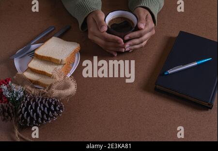 drinking coffee with bread, creating new ideas at my desk Stock Photo