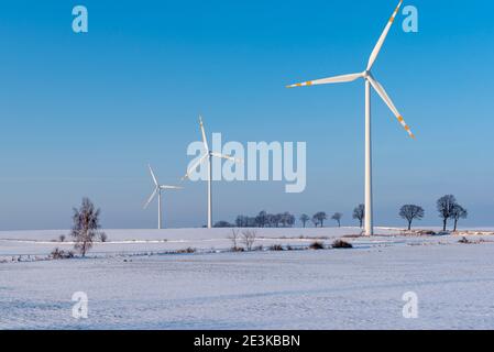 Windmills for electric power production. Winter landscape in northern Poland. Europe