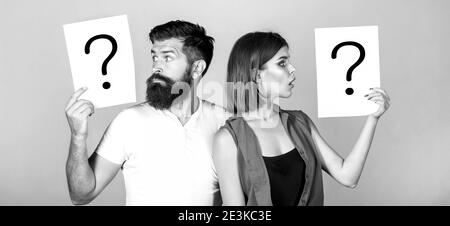 Confused couples with question marks. Conflict between two people. Pensive man and a thoughtful woman, conflict. Black and white Stock Photo