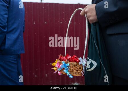 groom in a blue dress holds a bouquet of flowers in her hands, the wedding tradition is to throw a bouquet to the girls, fresh flowers br Stock Photo