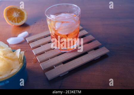 Two spritz with some chips on the table ready for the appetizer during the happy hour . One sprtiz is mixed with aperol and one with campari. High qua Stock Photo