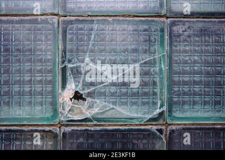 Old broken glass block window, close up view. Stock Photo