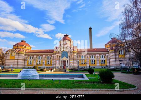 Regional History Museum and Central Mineral Baths Sofia and people walking around the park in front of it. Stock Photo