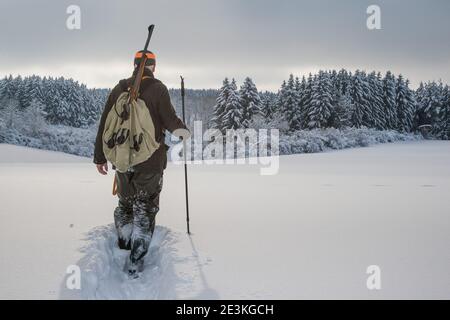 Hunter with a Backpack and a Hunting Gun in the Winter Forest. Stock Photo  - Image of backpack, hunter: 102837912