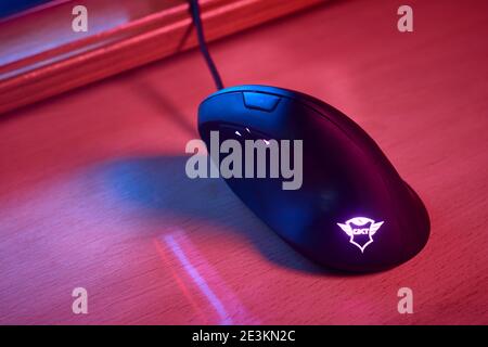 JANUARY 11, 2021 - BUENOS AIRES, ARGENTINA: Ergonomic gamer vertical mouse on desktop in room with blue and red lights. Top view. Stock Photo