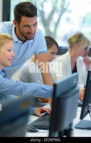 two students working on computers in classroom Stock Photo