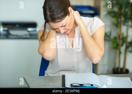 female office worker massaging aching neck Stock Photo