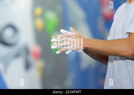rock climber putting chalk on hands Stock Photo