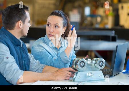 supervisor with female manual worker discussing in metal industry Stock Photo