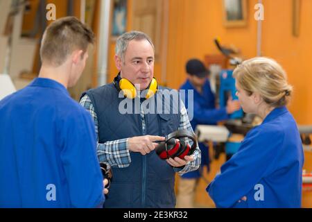 young students apprentice in workshop Stock Photo