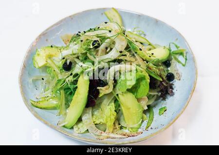 sliced fennel, asparagus, mixed lettuce and avocado salad, vegan food Stock Photo