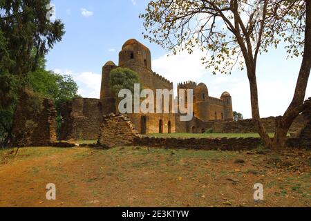 The Iyasu and Failedes palaces rise towards a blue sky above the crumbling courtyard walls in Gonder, Ethiopia, considered the Camelot of Africa. Stock Photo