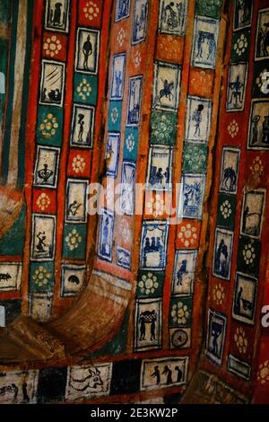 Pictograms of human images, interspersed with flowers decorate the large beams forming the supporting structure of the Azewa Mariam Monastery on Lake Stock Photo