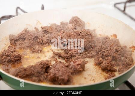 Stir fried ground beef browning in a frying pan Stock Photo