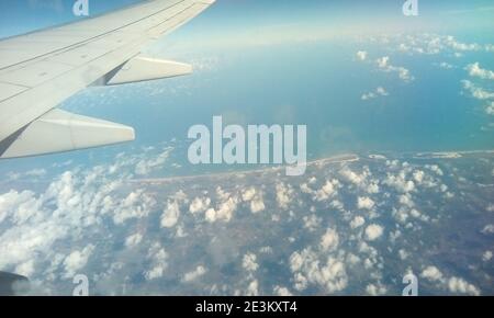 Aerial photography in Brazil. Earth surface viewed from airplane. Aerial view of the sky and the sea with clouds above earth. Stock Photo