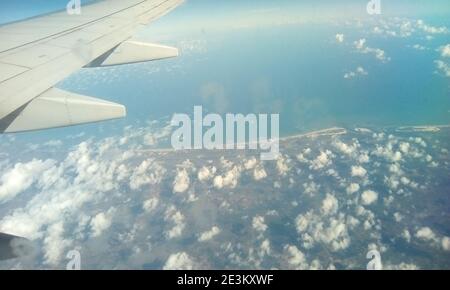Aerial photography in Brazil. Earth surface viewed from airplane. Aerial view of the sky and the sea with clouds above earth. Stock Photo