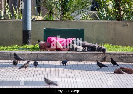 Buenos Aires, Argentina. 26th Oct, 2019. A homeless man sleeps among doves on a sideway.Known for its eclectic European architecture and a rich cultural life, Buenos Aires, with a population of about 3 million people (16 if you consider the Greater Buenos Aires) is thriving and full of life, a city with a rhythm of its own. Credit: Patricio Murphy/SOPA Images/ZUMA Wire/Alamy Live News Stock Photo