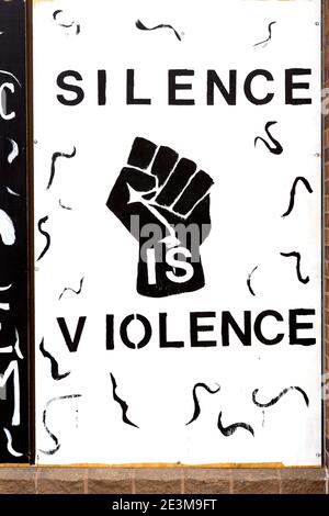 Painted mural on boards over a storefront window stating Silence is Violence during the civil unrest after the killing of George Floyd in Minneapolis, Stock Photo