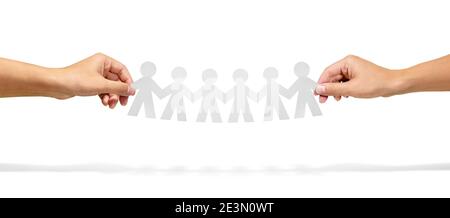Community, unity and teamwork concept - hands holding paper chain people over white background Stock Photo
