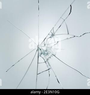 Broken window glass crack splitter on white gray background Stock Photo