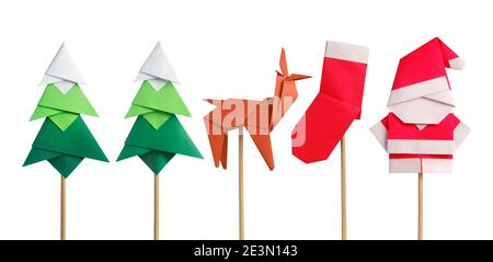 Handmade origami paper craft Santa Claus, green Christmas trees, reindeer and stocking isolated on white Stock Photo
