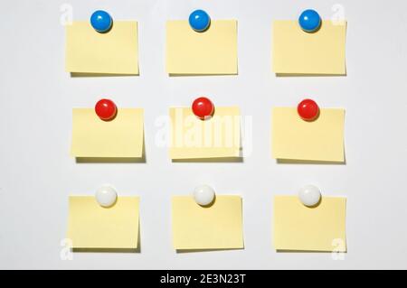 Yellow post it note and magnet button on whiteboard Stock Photo