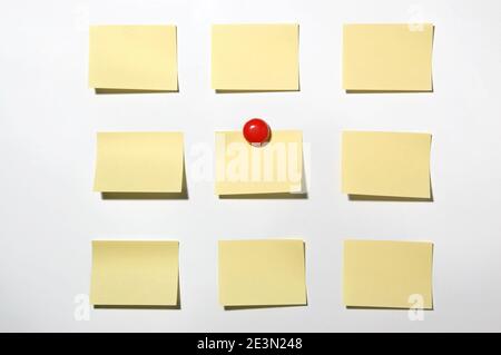 Yellow post it note and magnet button on whiteboard Stock Photo