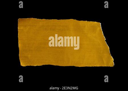 gold ripped pieces of paper on black background Stock Photo