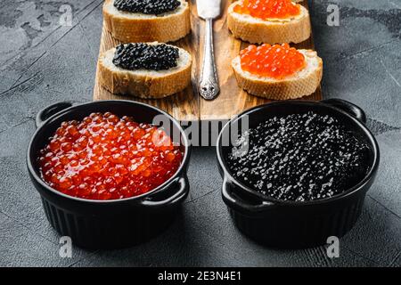Canapes with black sturgeon, and salmon fish caviar, on gray background Stock Photo