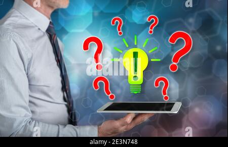 Problem solving concept above a tablet held by a man Stock Photo