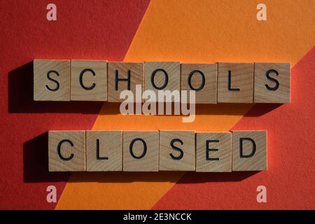 Schools Closed, words in wooden alphabet letters. Strategy to control the spread of Coronavirus in England during the pandemic. Stock Photo